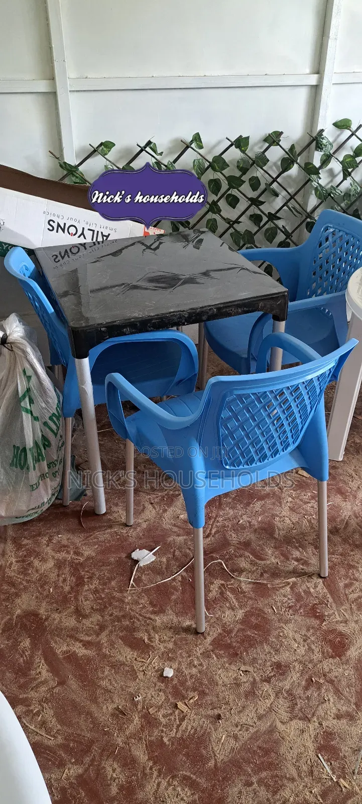 A Black Plastic Table With 3 Blue Plastic Chairs Set