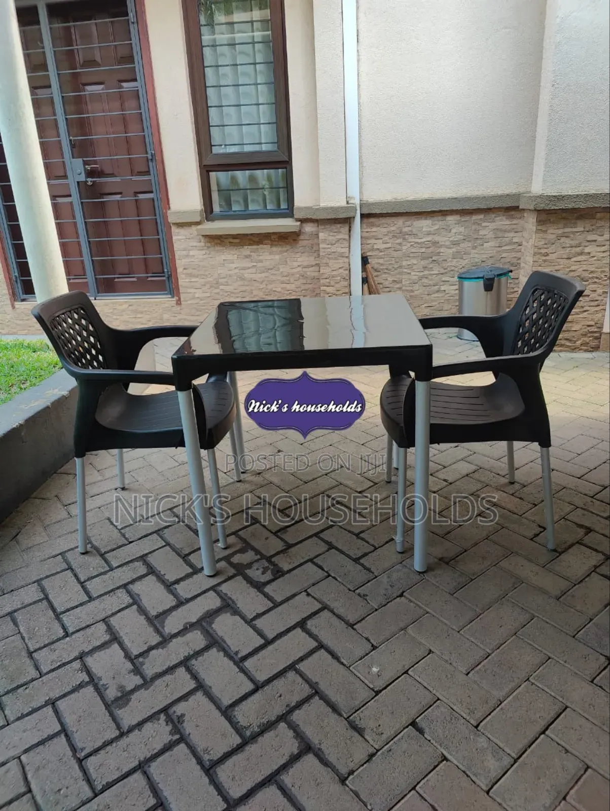 2 Plastic Chairs With a Plastic Table
