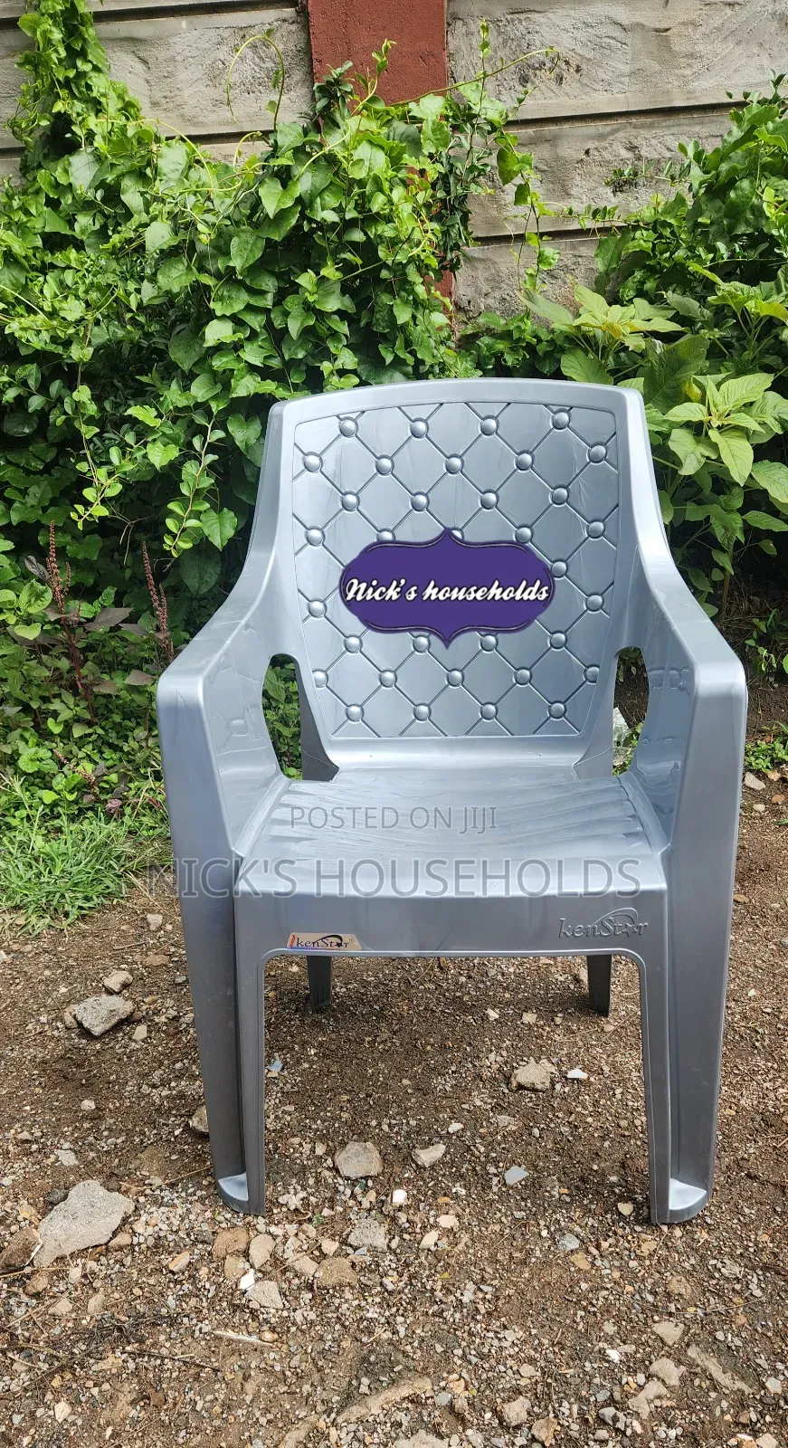 Gray Plastic Chair With High Arms And Pattern Backrest