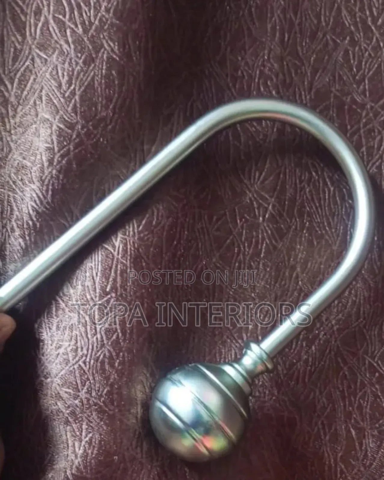 Metallic Curtain Tieback Hooks That Are Mounted on the Wall