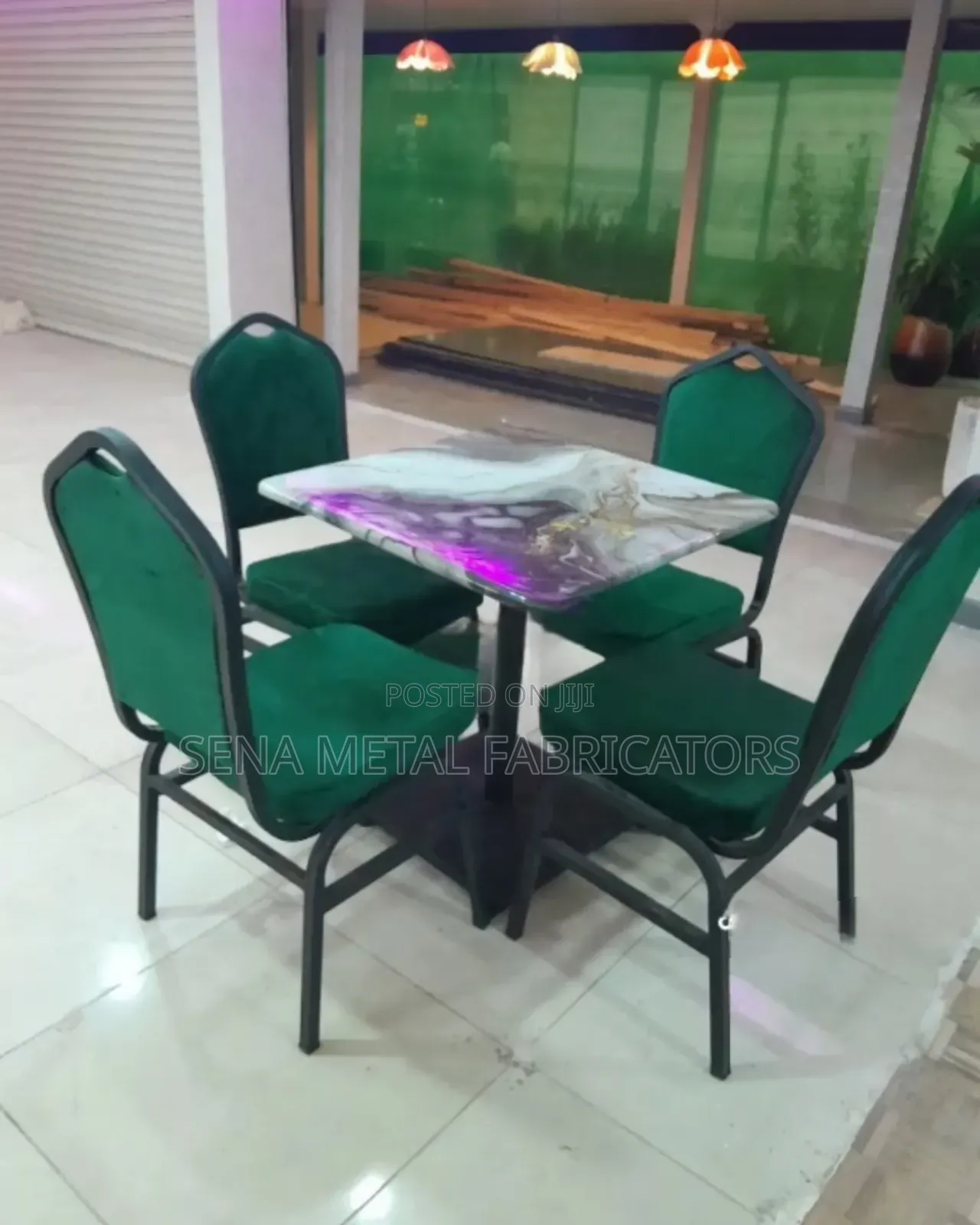 Restaurant With Emerald Chairs and a Modern Dining Table.