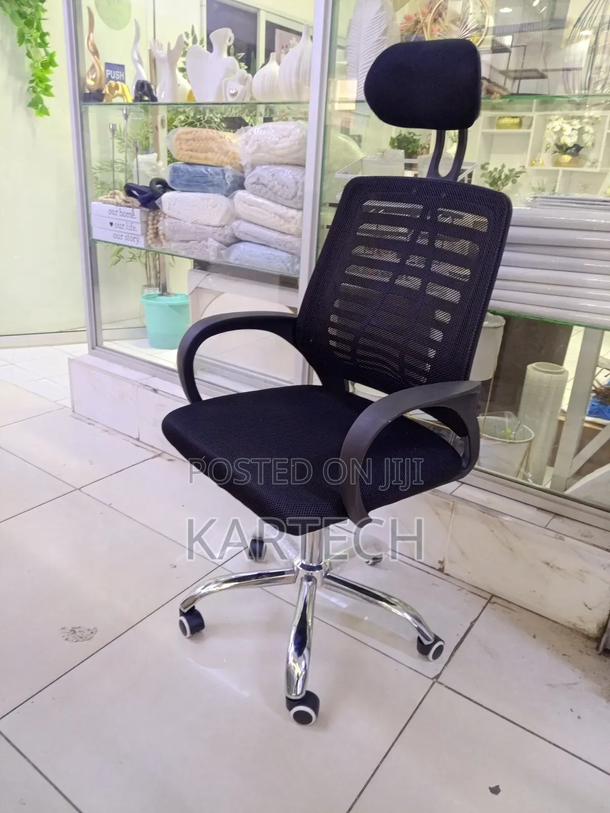 High-Back Mesh Office Chair With a Headrest and Armrests.