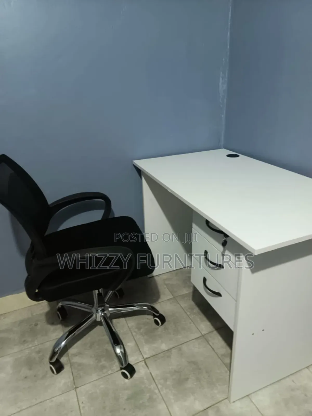 White Office Desk With a Black Ergonomic Office Chair
