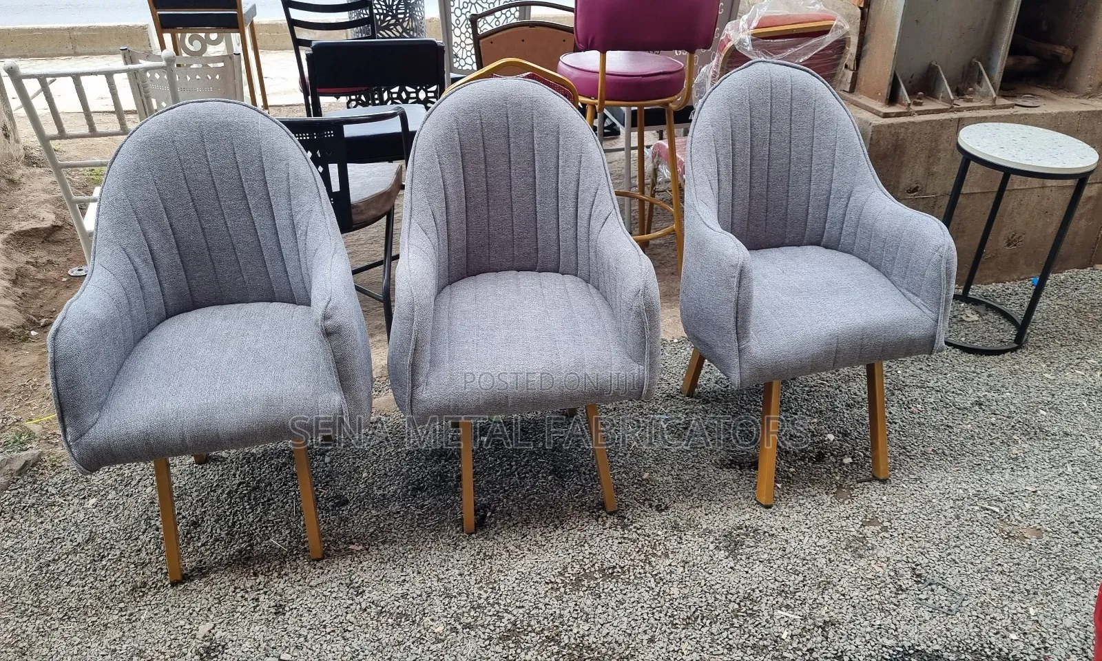 Modern Grey Upholstered Chair With Gold Base.
