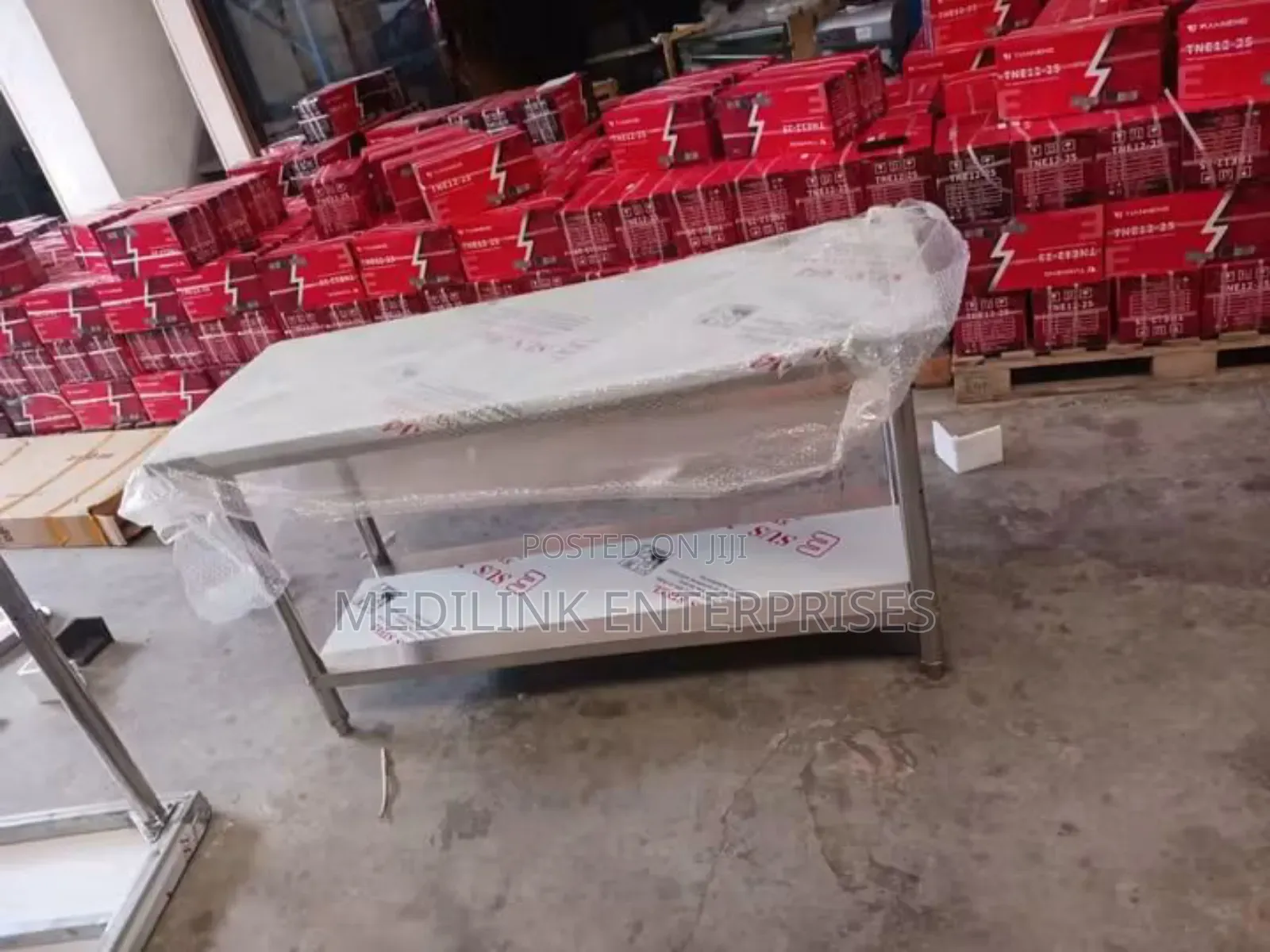 Stainless Steel Commercial Kitchen Working to Tables