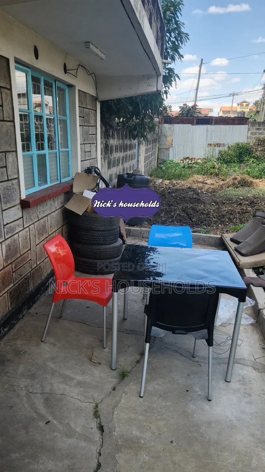 Red ,Black and Blue Plastic Chairs Plus a Square Plastic Table
