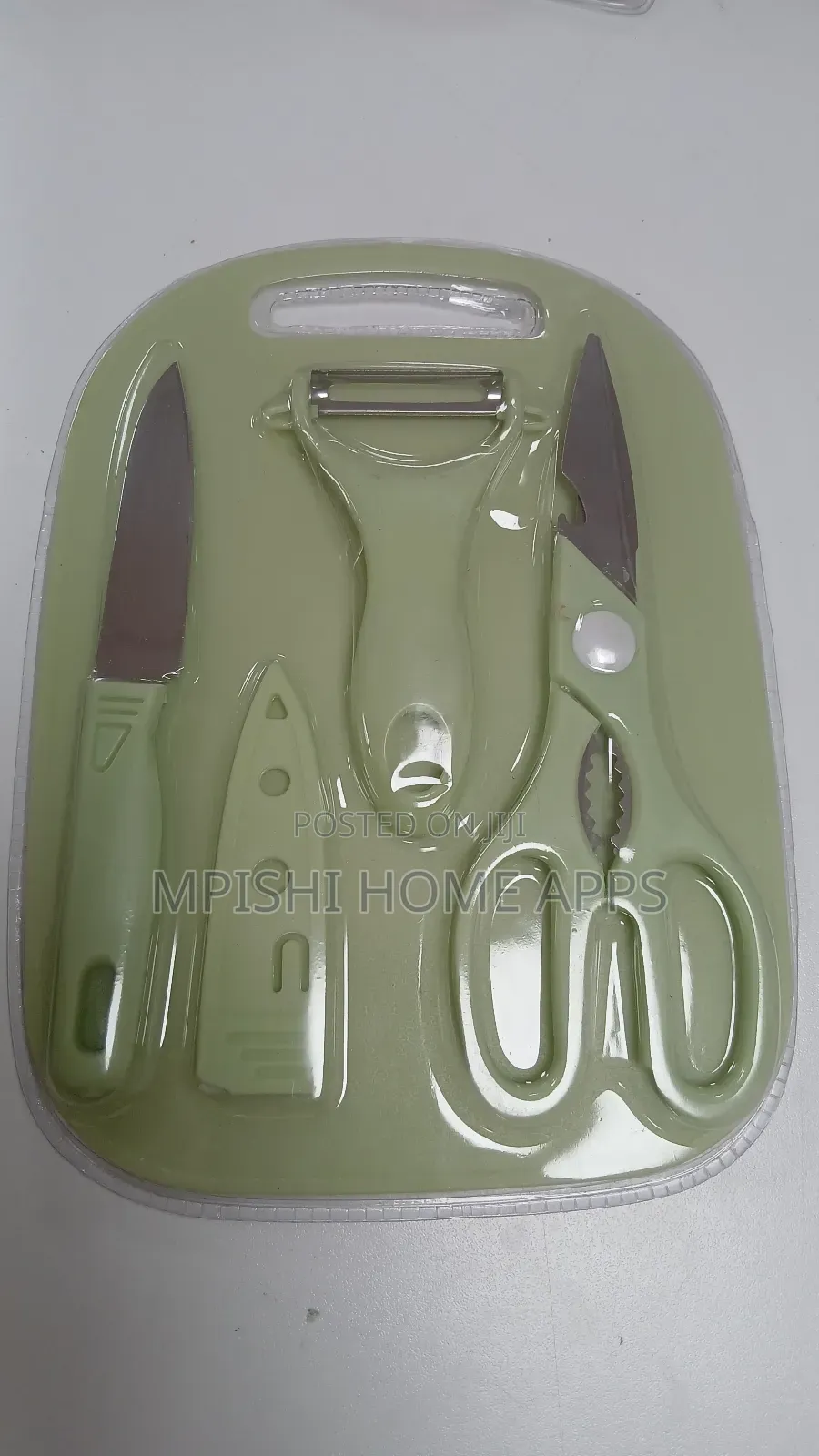 4-Piece Kitchen Set, a Knife, Peeler, Scissors, and a Cutting Board.