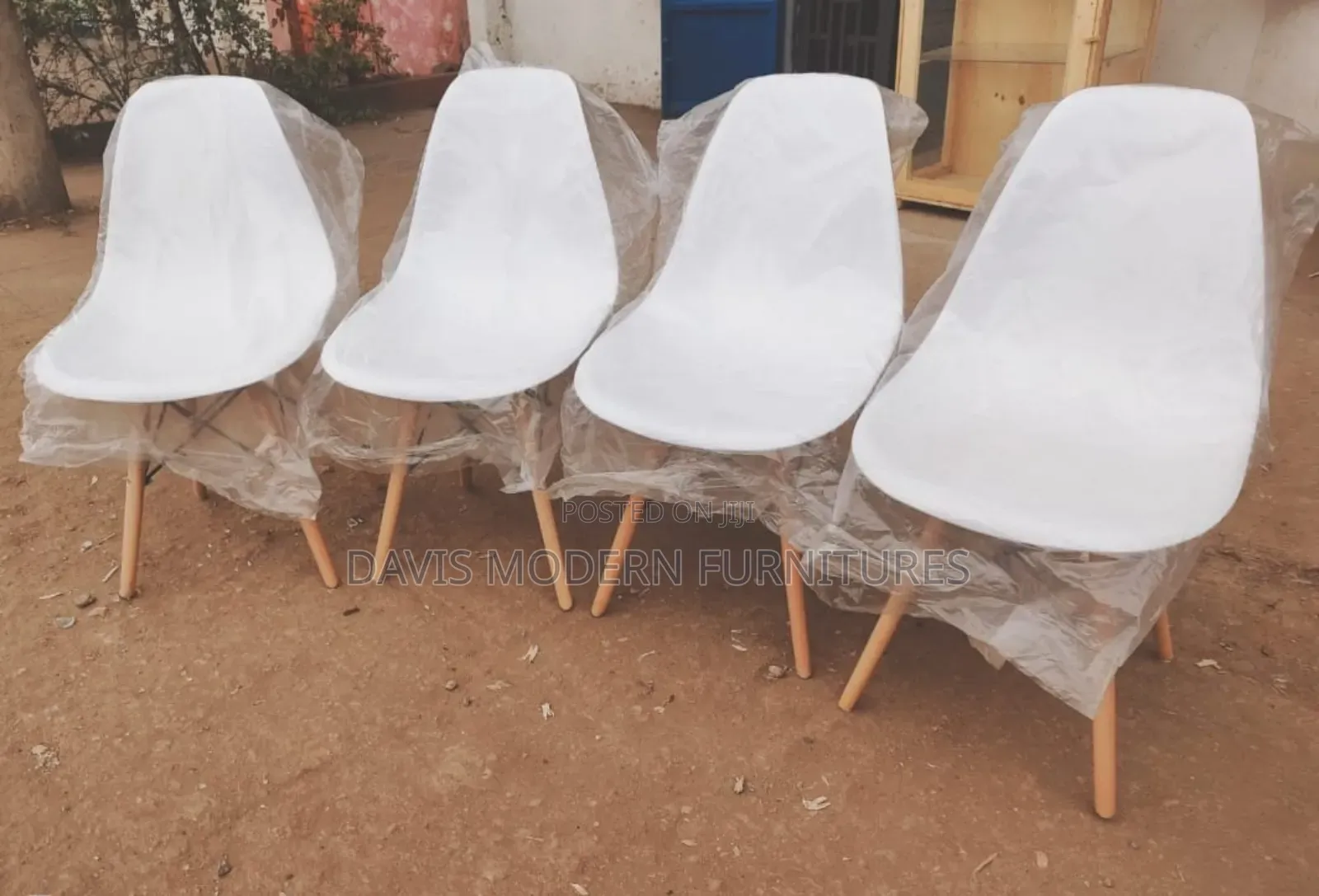 Four White Plastic Chairs With Wooden Leg