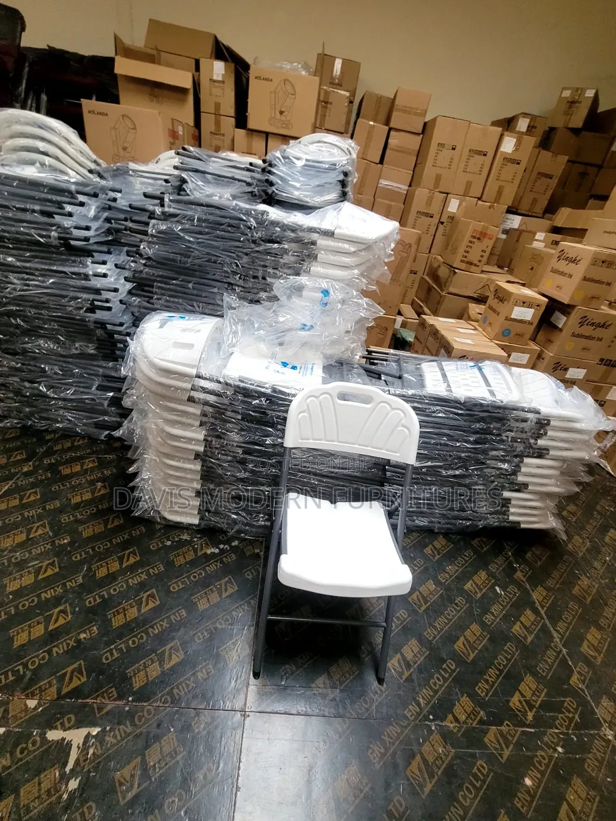 Stack of White Plastic Chairs