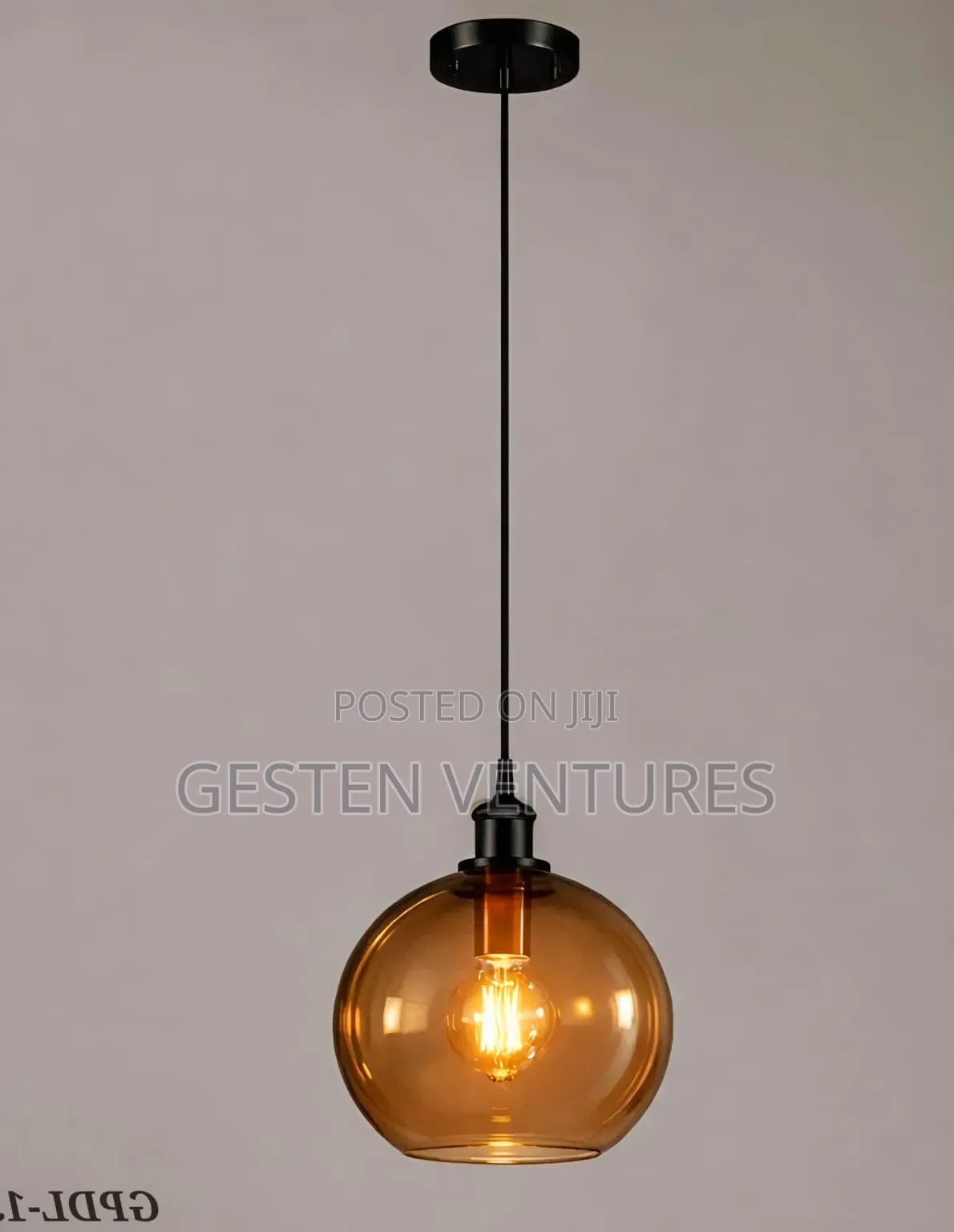 Amber Glass Globe Shade and a Black Metal Finish Pendant Light