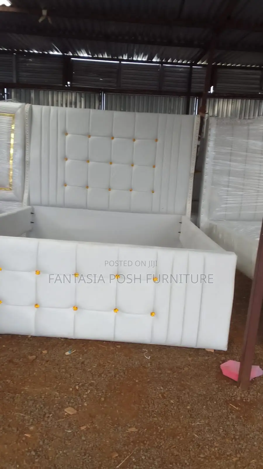 White Upholstered Bed With Gold Button Accents