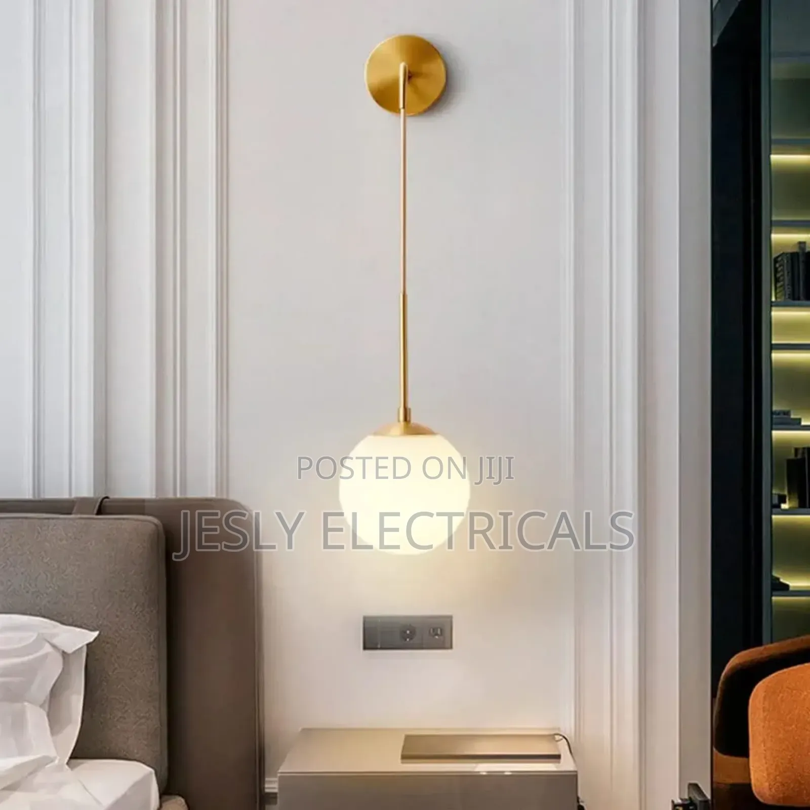 Modern Brass Wall Light With a White Glass Globe Shade.
