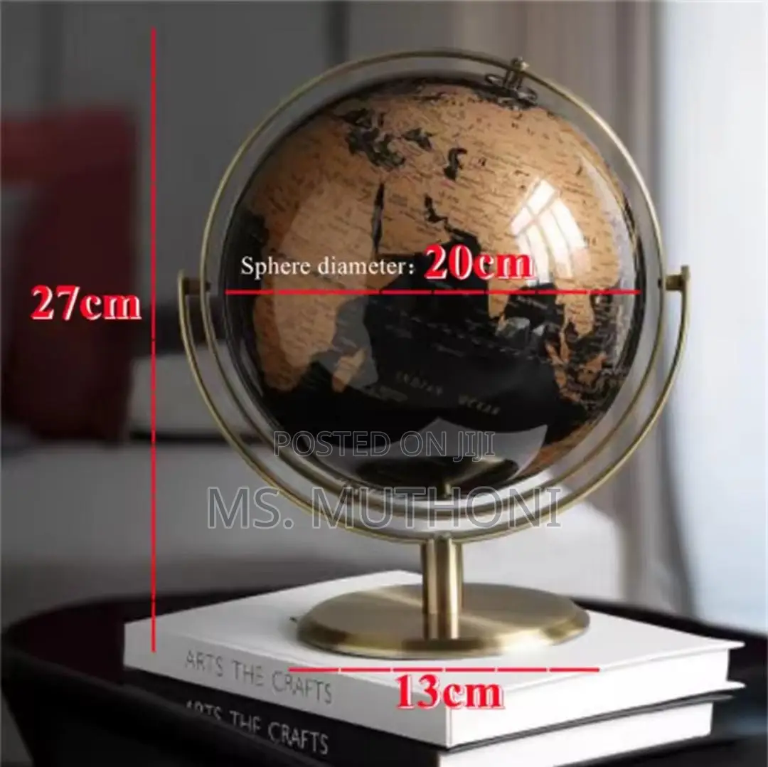 Black and Gold Rotating World Globe With a Metal Stand.