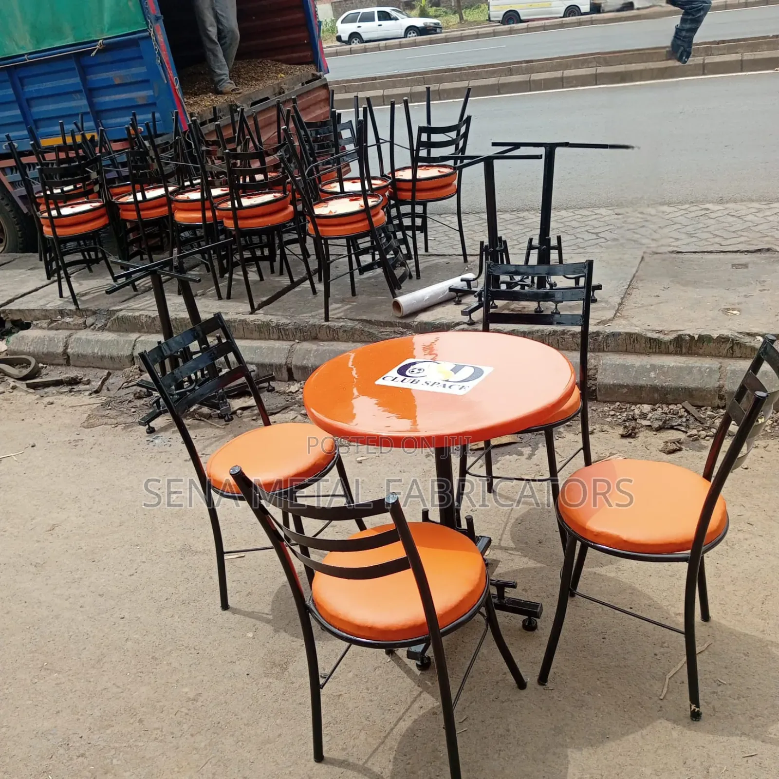 Branded Restaurant/Hotel Table With Orange Chairs.