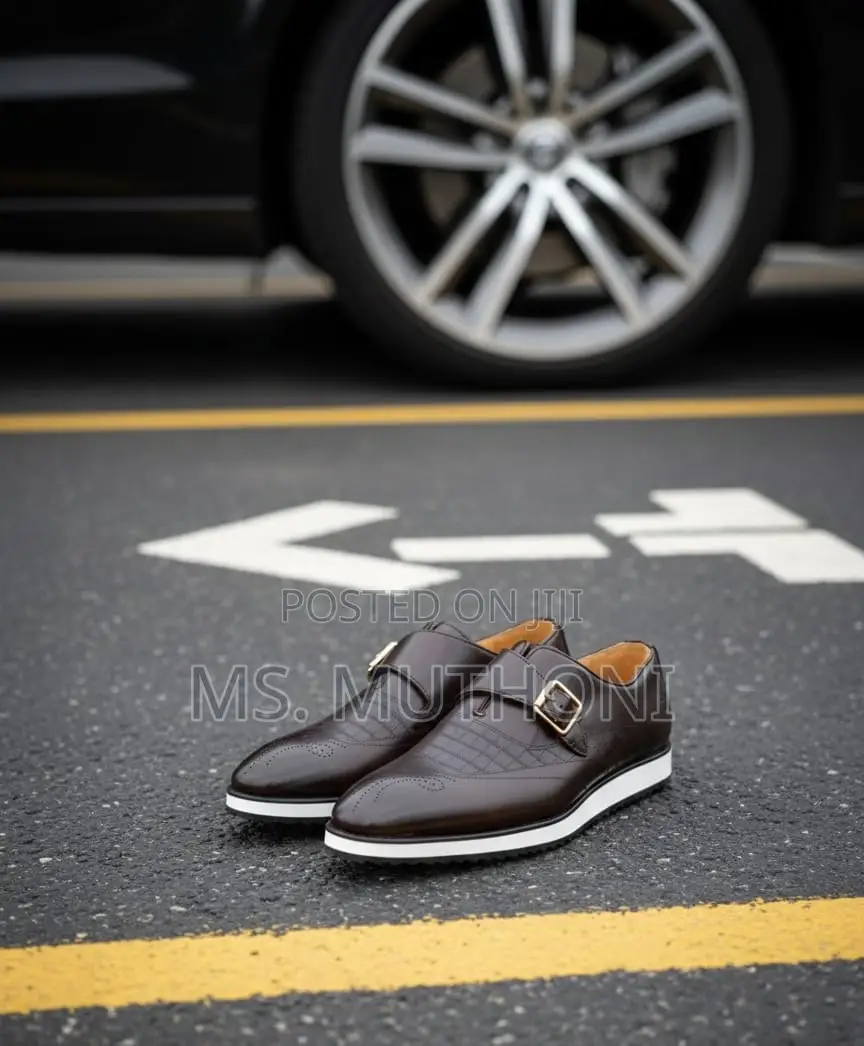 Monk Strap Dress Shoes With a White Sole and a Gold-Tone Buckle.