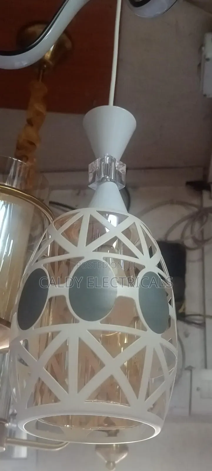 Glass and Metal Pendant Light With a White Geometric Overlay
