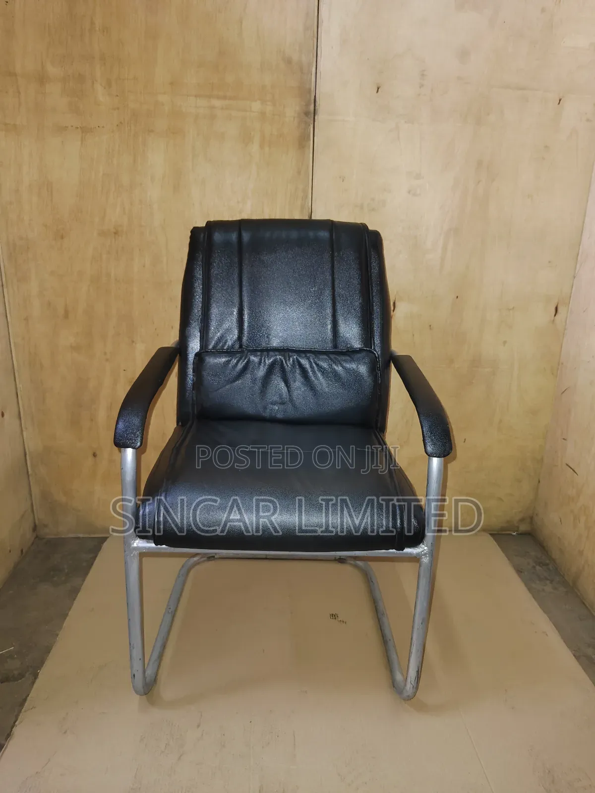 A Black Faux Leather Cantilever Office or Visitor Chair