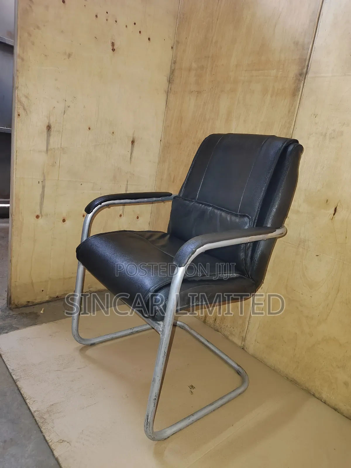 A Black Faux Leather Cantilever Office or Visitor Chair
