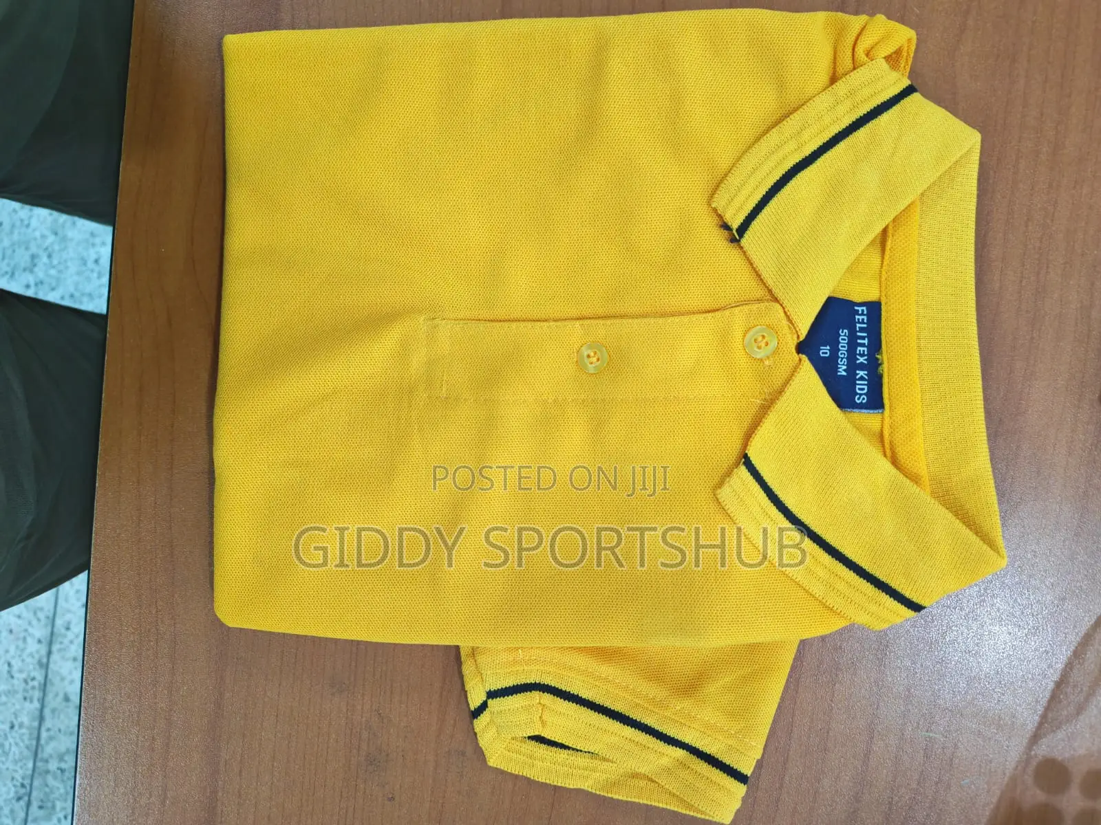 Yellow, With Black Stripes on the Collar and Cuffs.