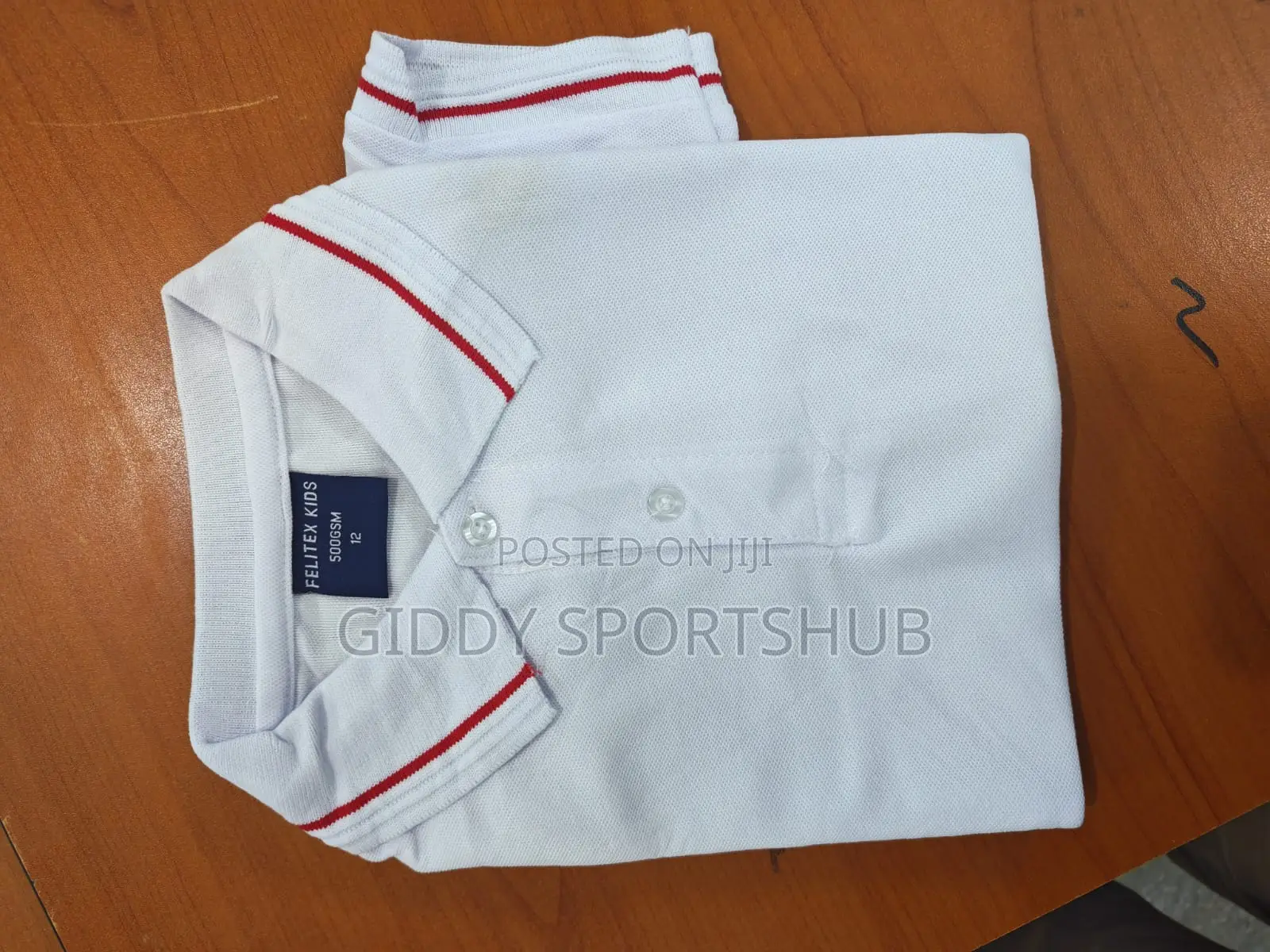 Polo Shirt With Red Stripes on the Collar and Cuffs.