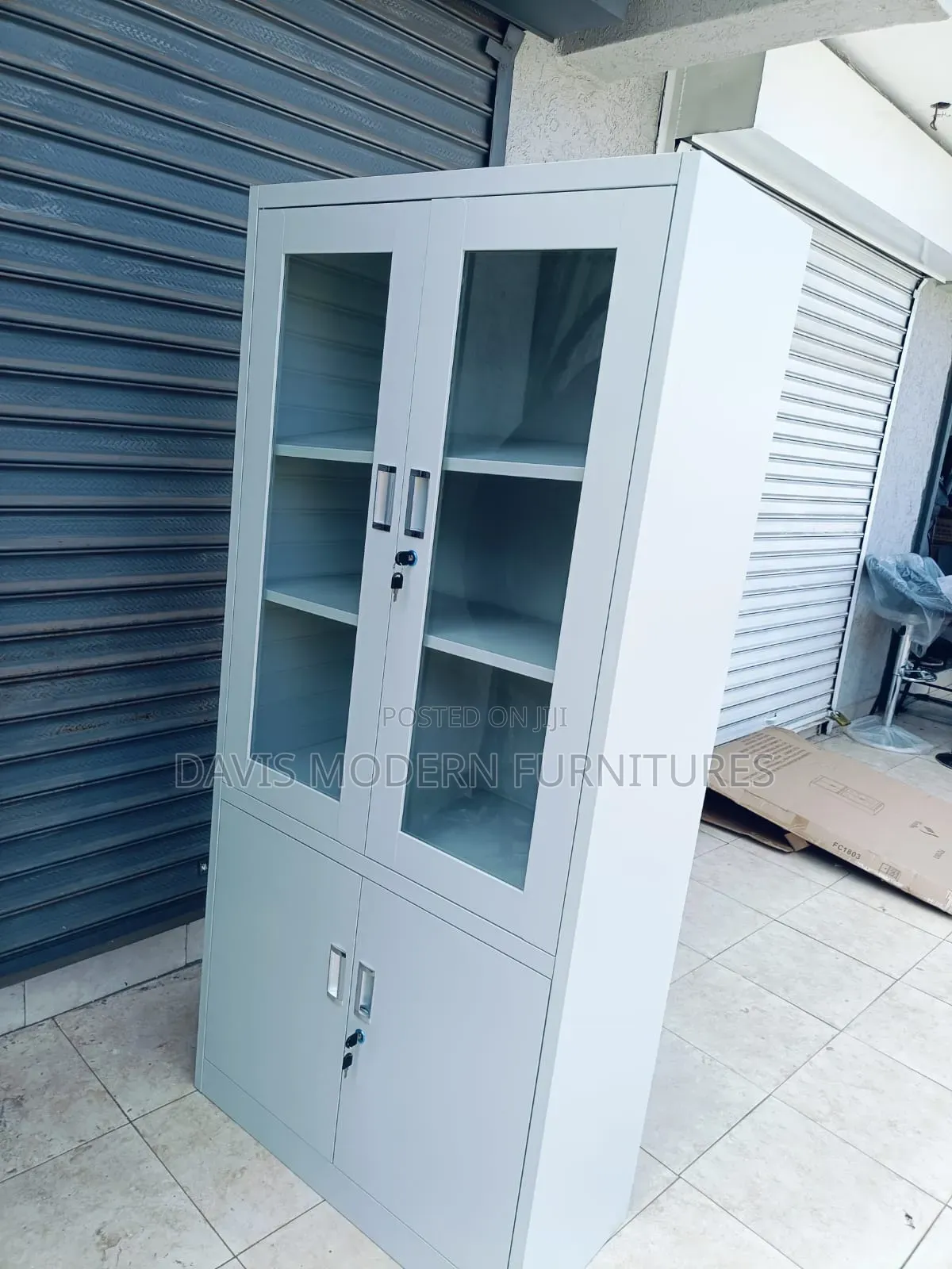 A White Metal Cabinet With Glass