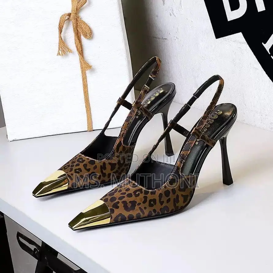 Slingback Heels Featuring a Pointed Toe With a Gold Metal Cap Pumps