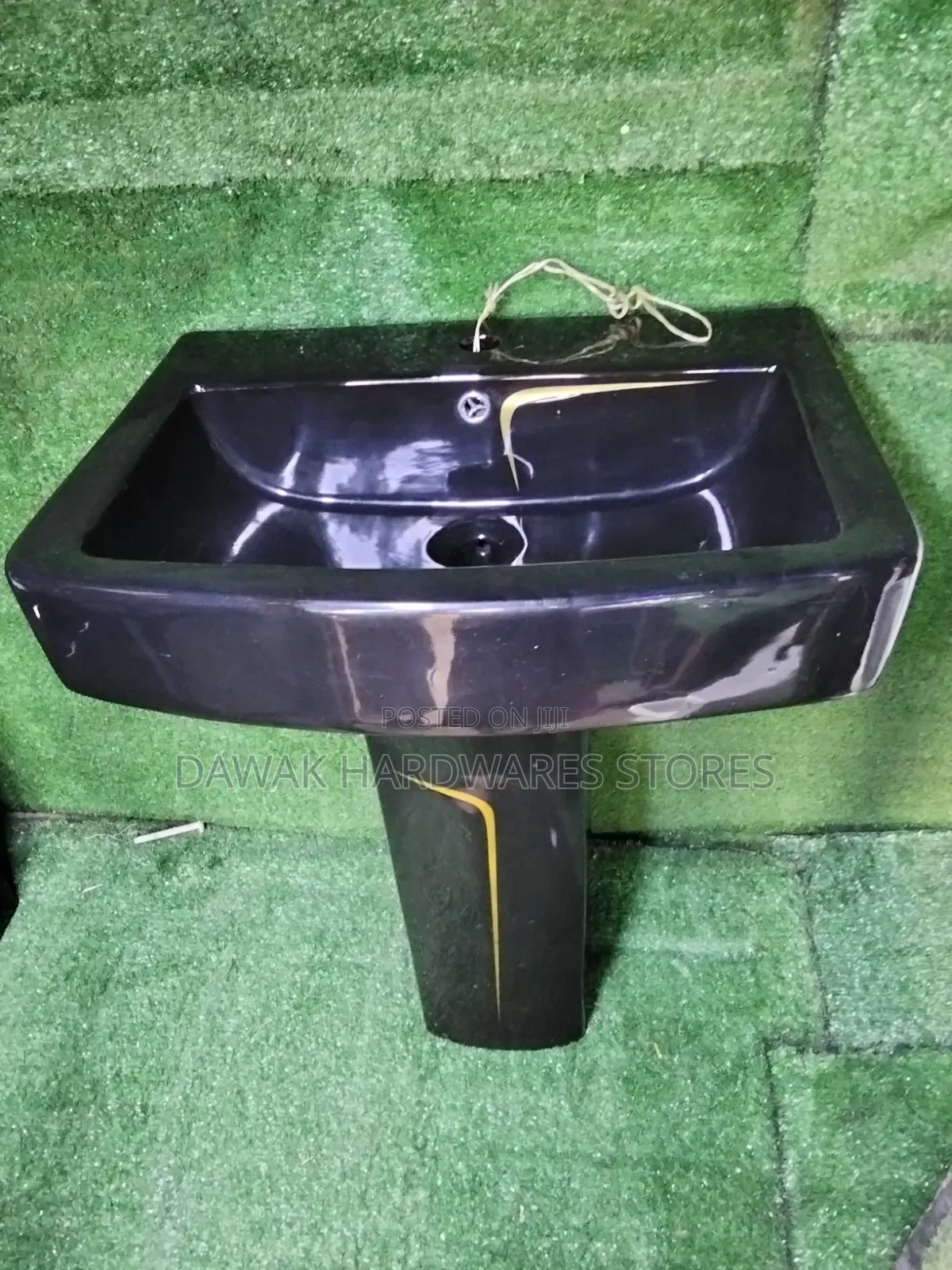 Black Designed Washhandbasin With a Gold Strip