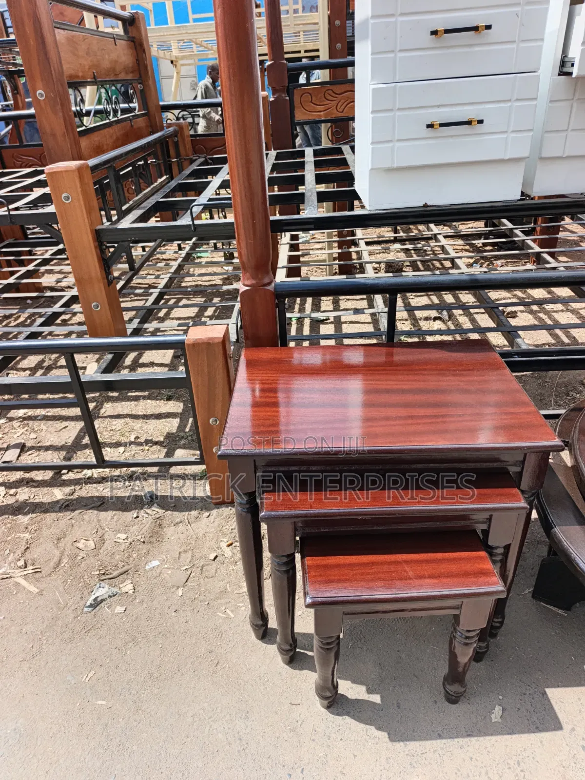 This Image Displays a Classic Mahogany-Finish Wooden Nesting Table Set