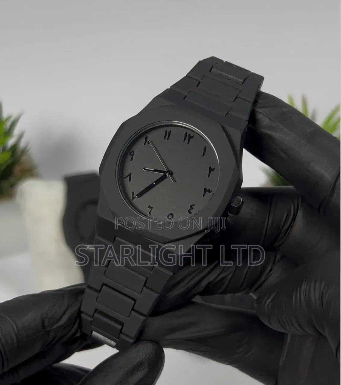 Modern All-Black Analog Watch With Eastern Arabic Numerals Dial