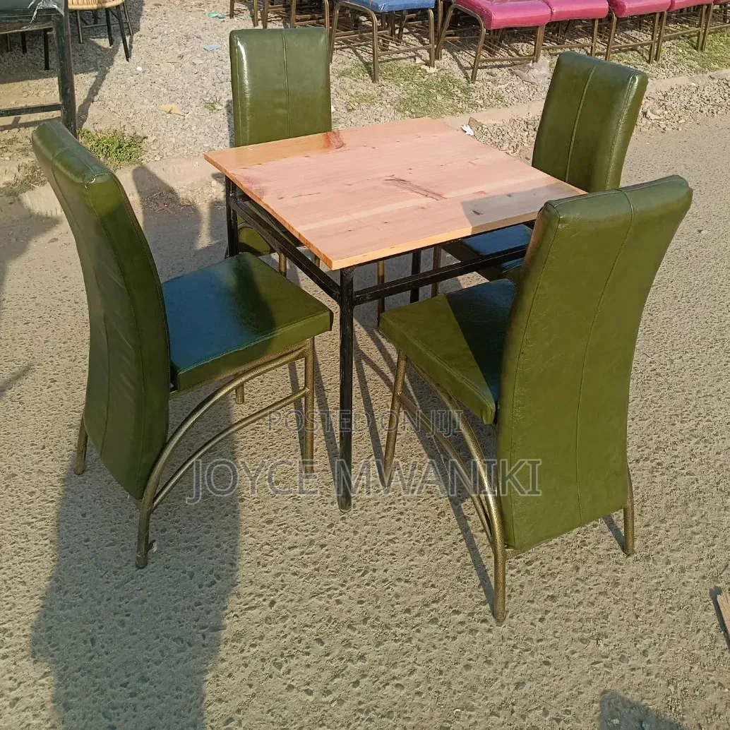 Restaurant Set With Green Chairs and a Wooden Square Table