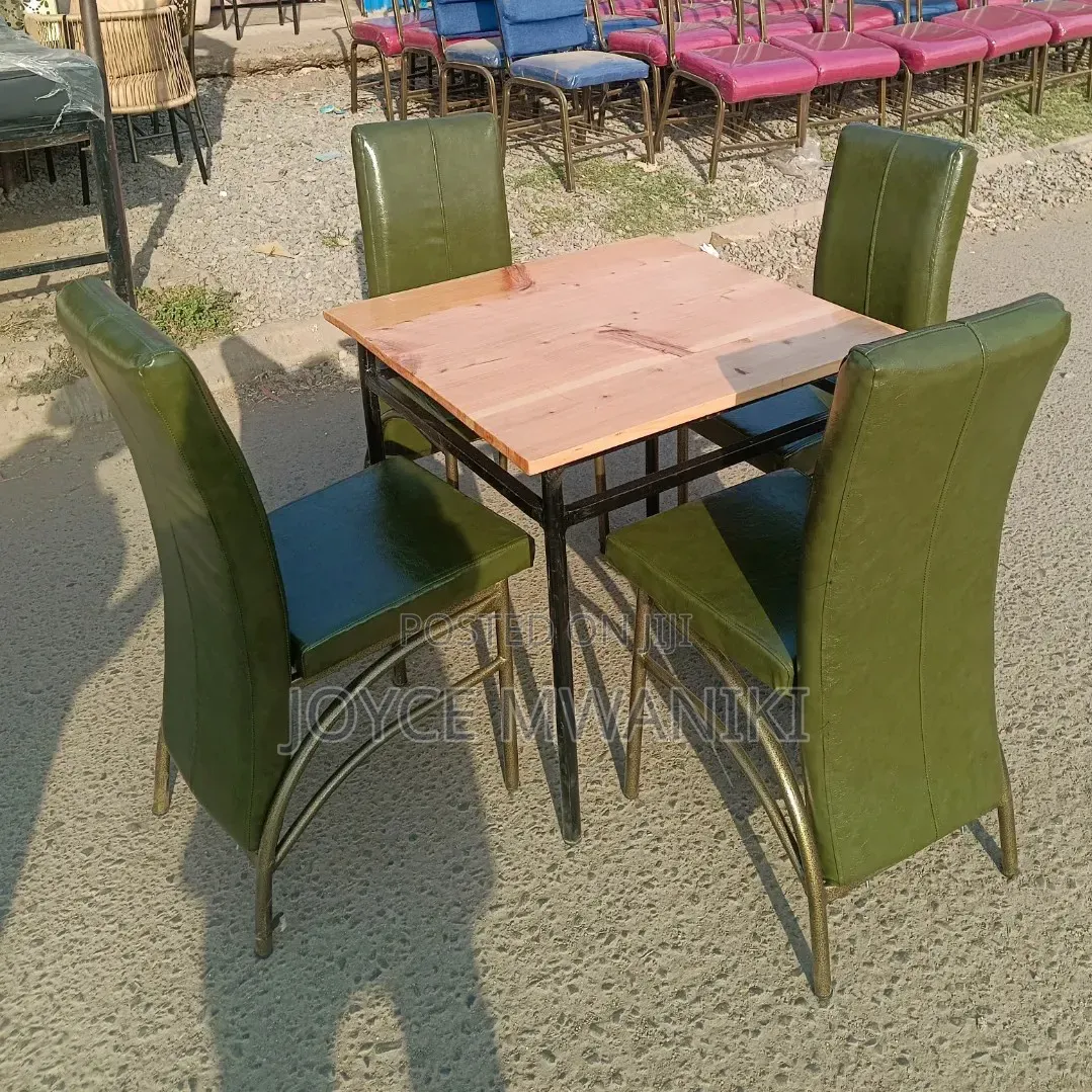 Restaurant Set With Green Chairs and a Wooden Square Table