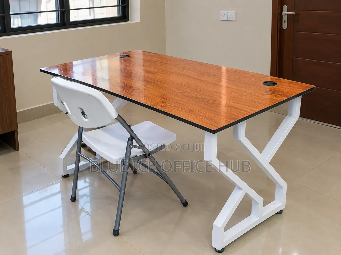 Brown Office Desk With White Metal Frame and Folding Chair