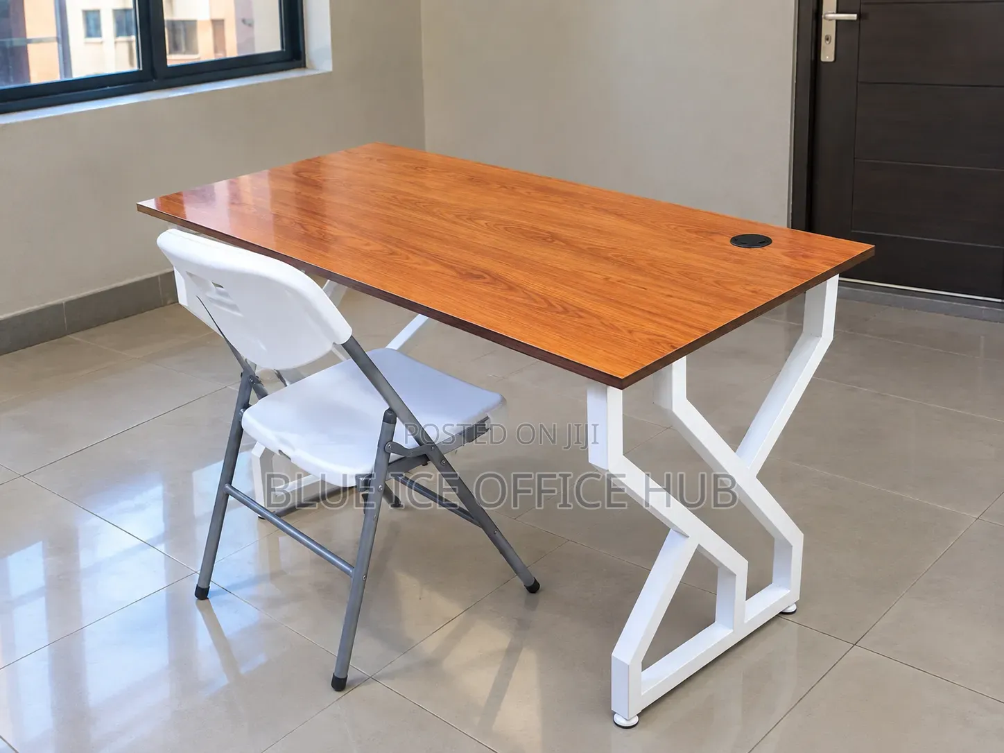 Brown Office Desk With White Metal Frame and Folding Chair