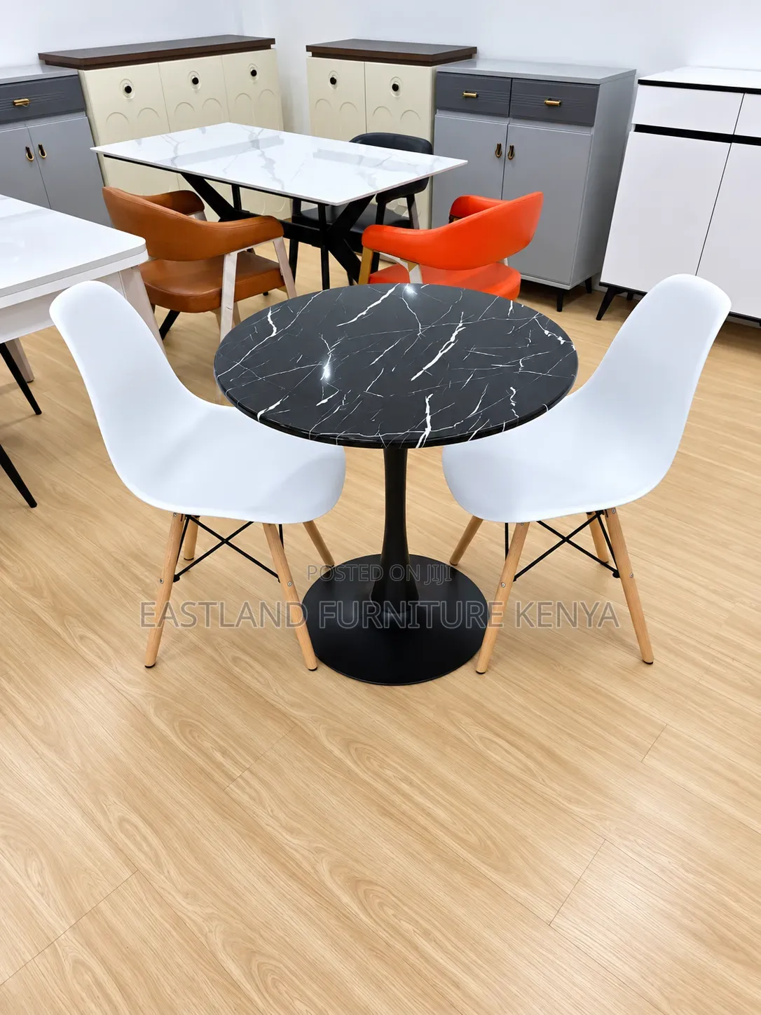 Modern Round Black Marble Dining Table With White Designer Chairs