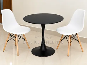 Black Round Table With White Eames Chairs