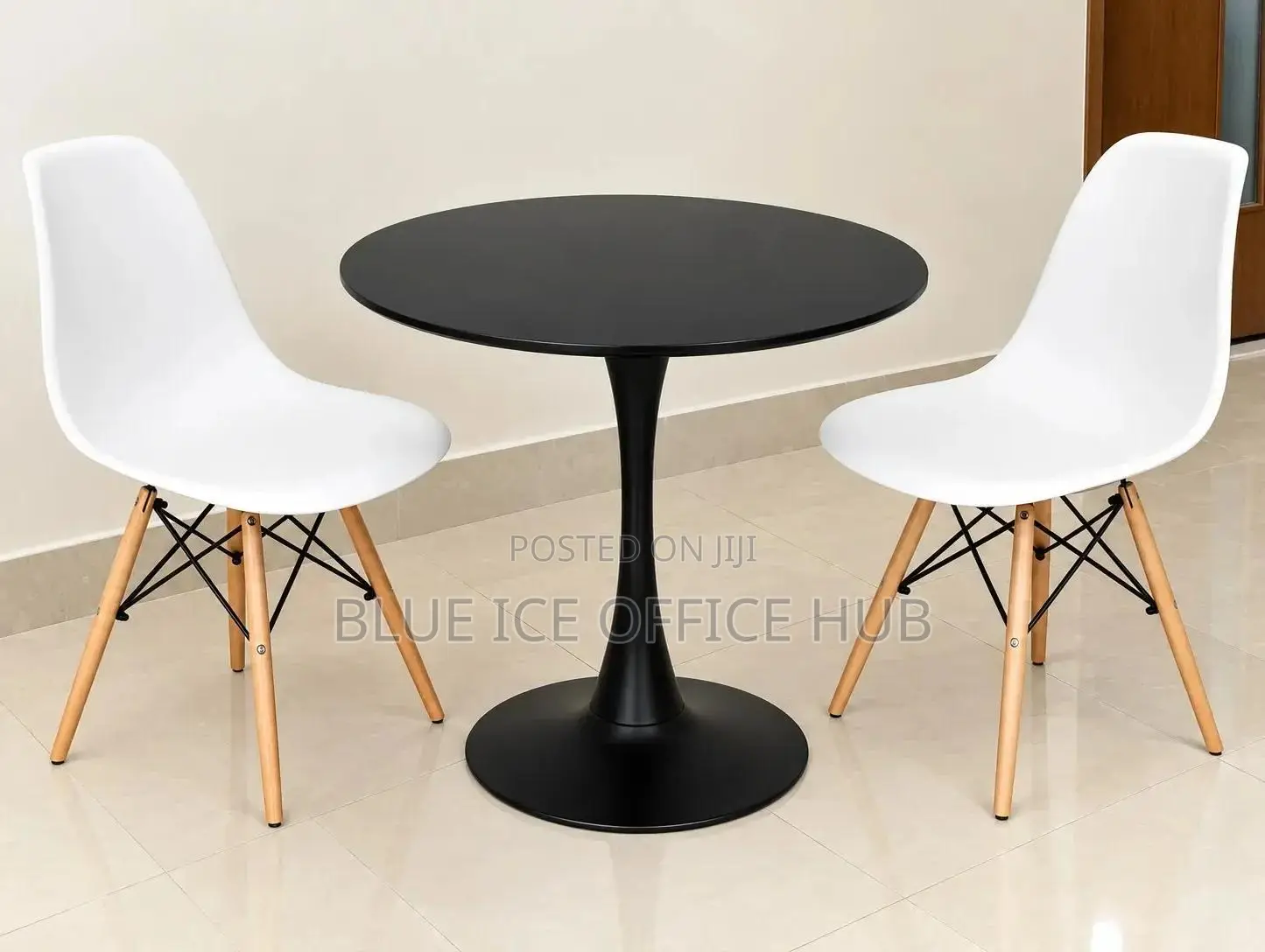 Black Round Table With White Eames Chairs