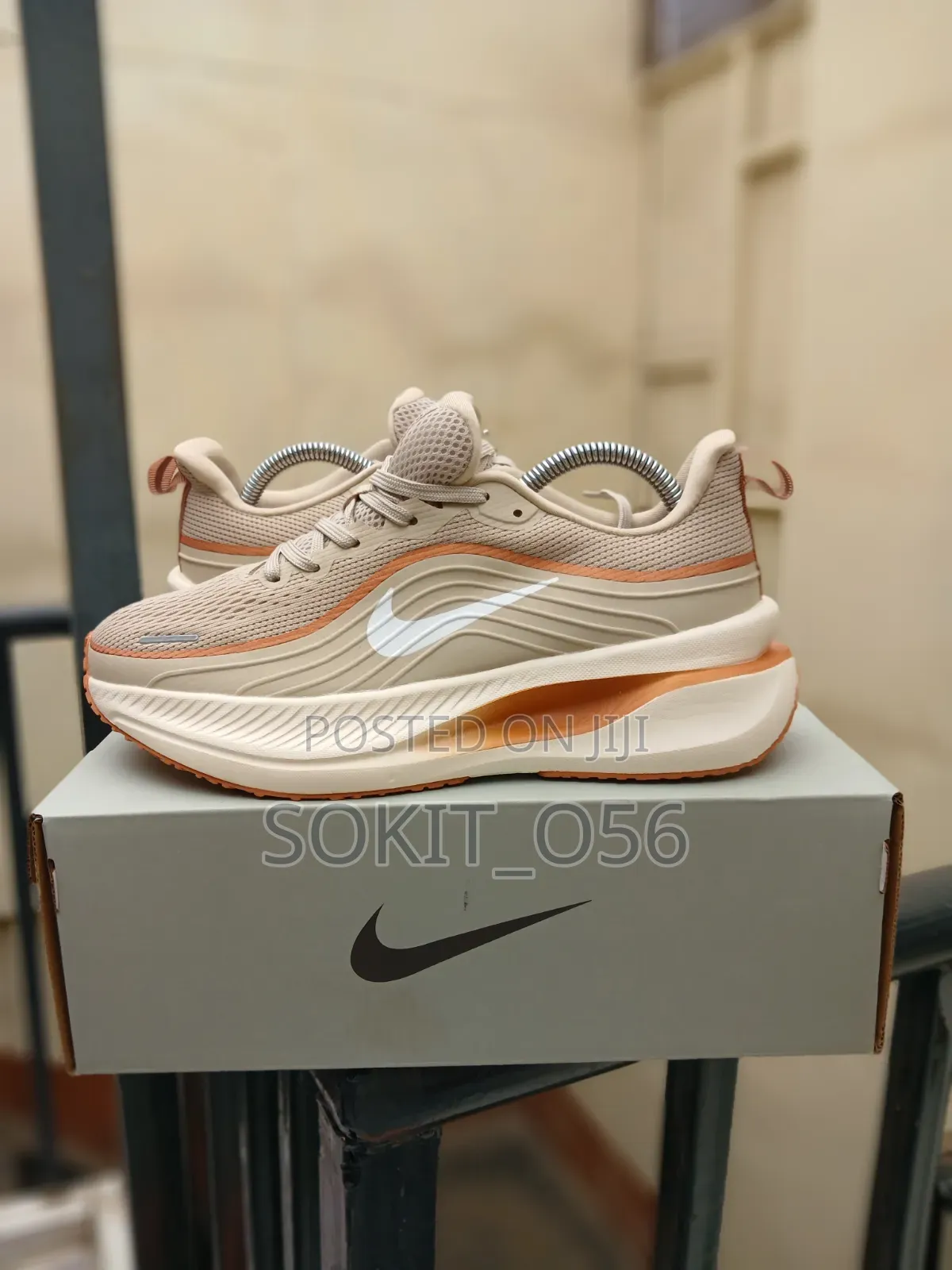 The Nike Vomero Plus in a Beige and Orange Colorway