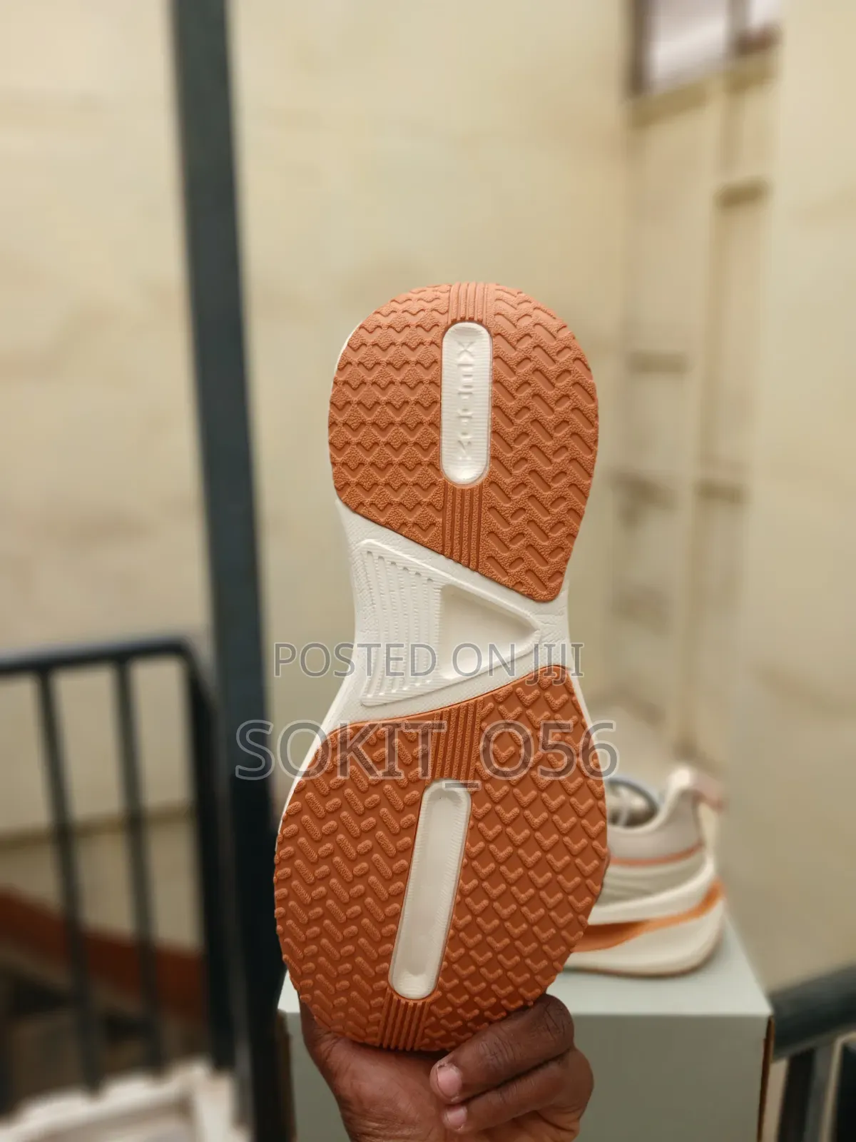 The Nike Vomero Plus in a Beige and Orange Colorway