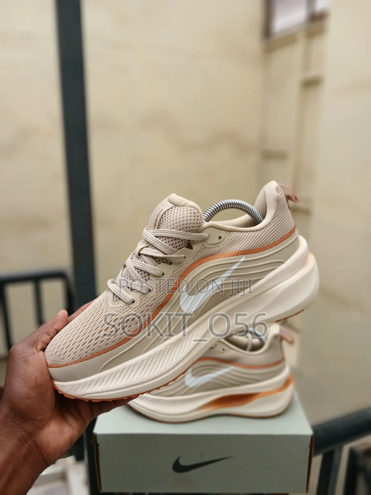 The Nike Vomero Plus in a Beige and Orange Colorway