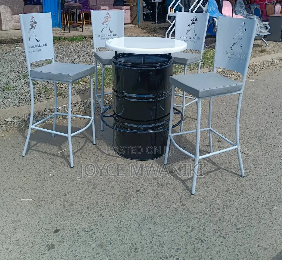 Antique White Coated Bar Chairs With a Black Drum Table