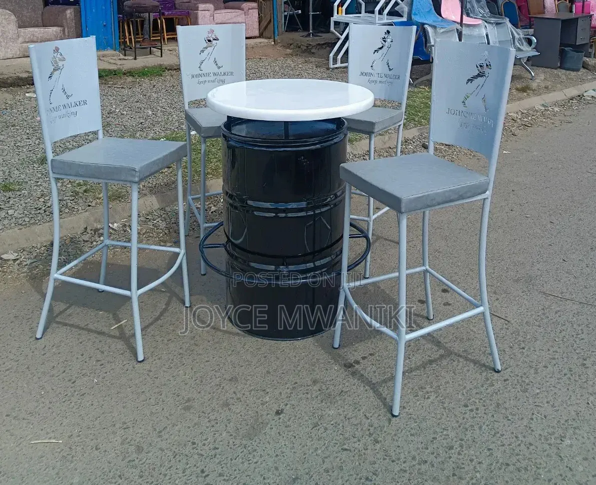 Antique White Coated Bar Chairs With a Black Drum Table