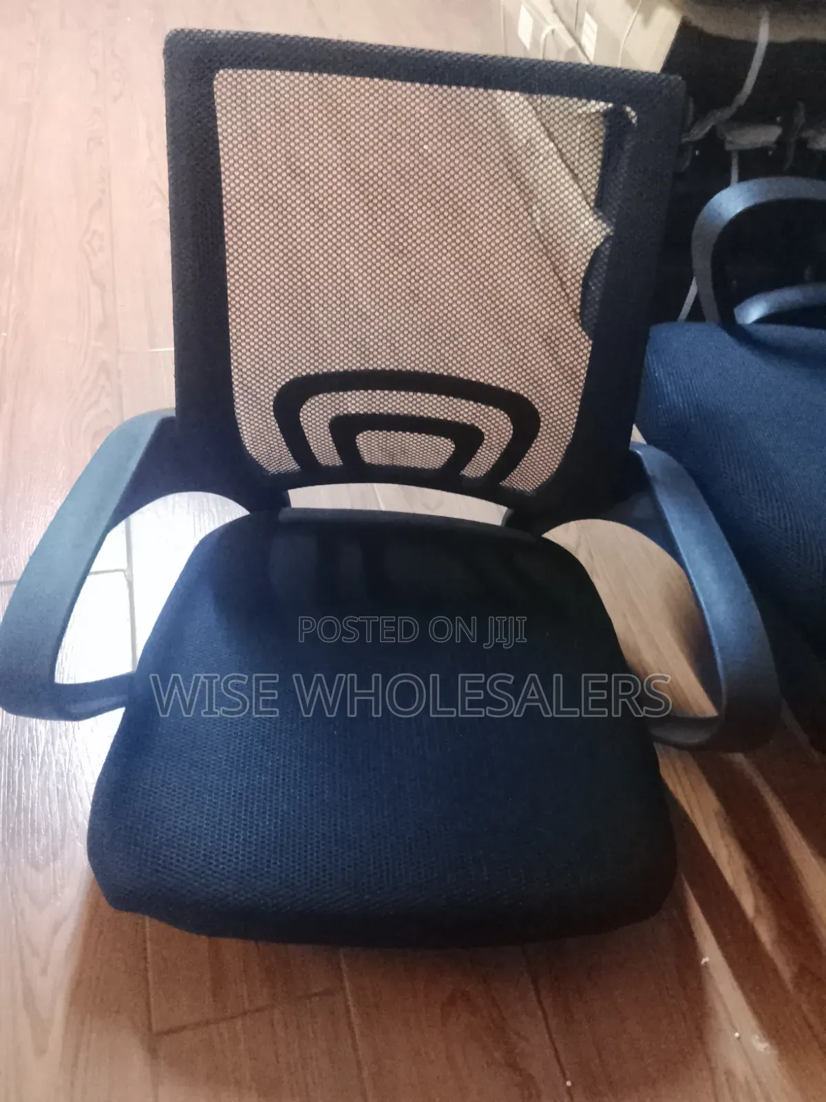 Black Mesh Office Chair With Padded Seat and Armrests