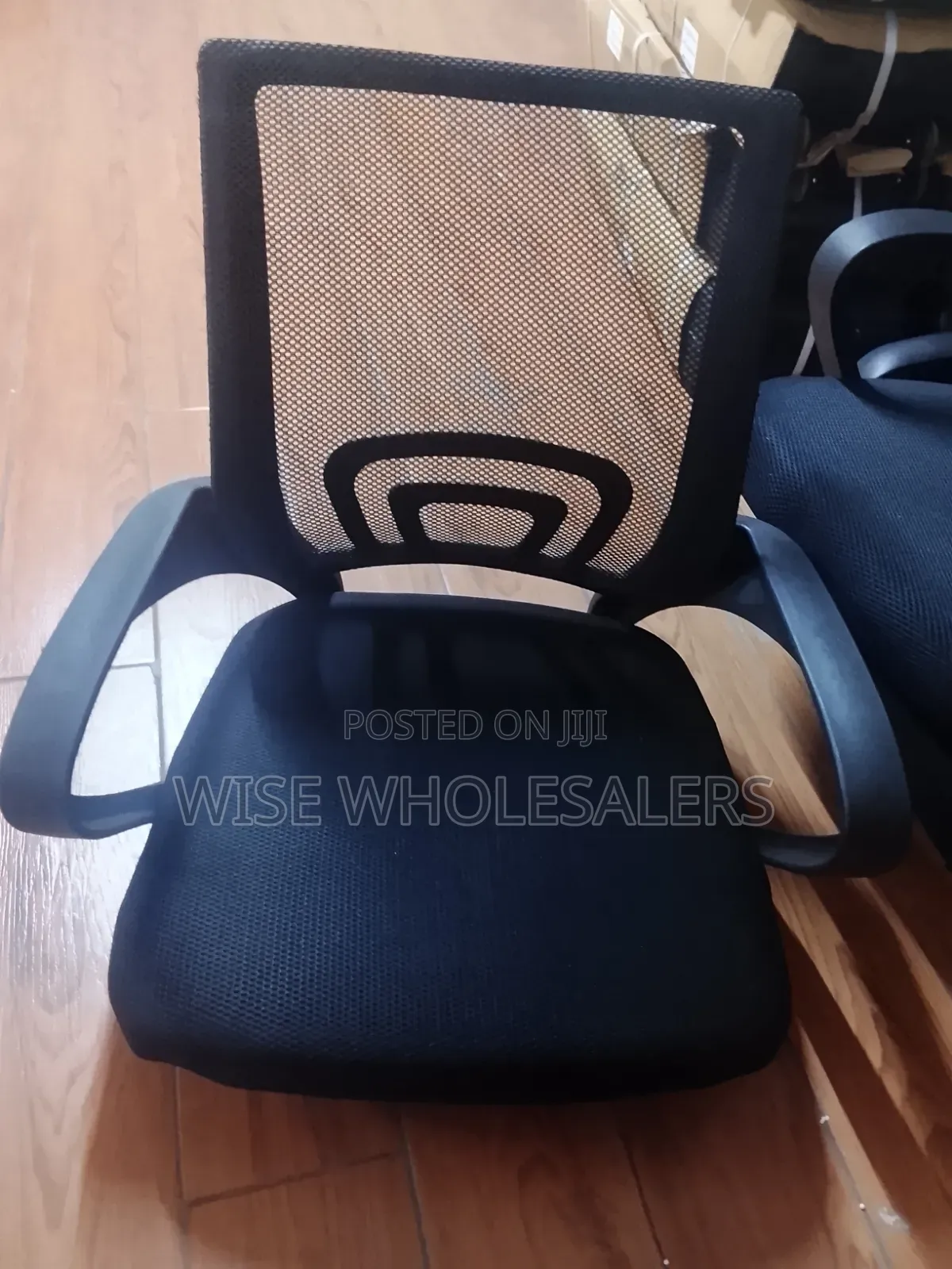 Black Mesh Office Chair With Padded Seat and Armrests